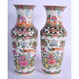 A PAIR OF 19TH CENTURY CHINESE CANTON FAMILLE ROSE VASES painted with figures. 21 cm high.