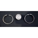 Two Chinese white metal bangles and a white metal coin box