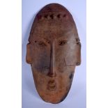 A LARGE SOUTH AMERICAN PRE COLUMBIAN POTTERY MASK HEAD of elongated form. 42 cm x 21 cm.