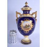 A LARGE ANTIQUE COALPORT TWIN HANDLED VASE AND COVER painted with castles and landscapes. 37 cm x 1