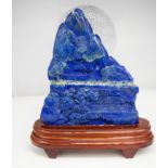 A Lapis lazuli carved boulder with stand 19cm x 14cm