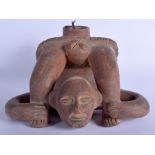 A SOUTH AMERICAN PRE COLUMBIAN POTTERY VESSEL modelled as a male holding his legs. 30 cm x 24 cm.