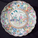 A large Chinese famille rose scalloped charger with figures in a land scape 37cm