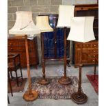 Four wooden Lamp Stands with shades. largest 159cm tall
