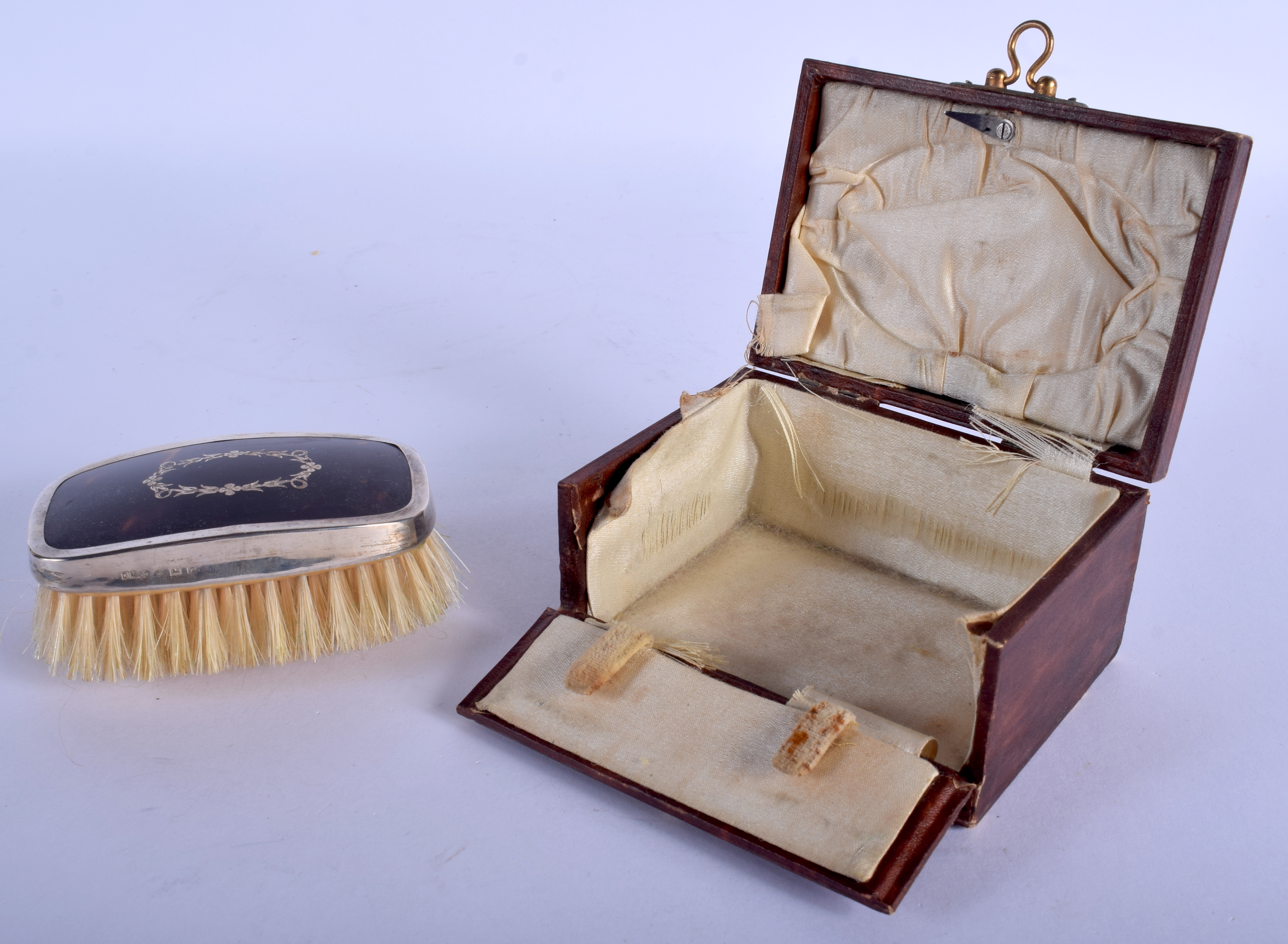 A BOXED ANTIQUE SILVER AND TORTOISESHELL BRUSH. 8 cm x 4.5 cm.