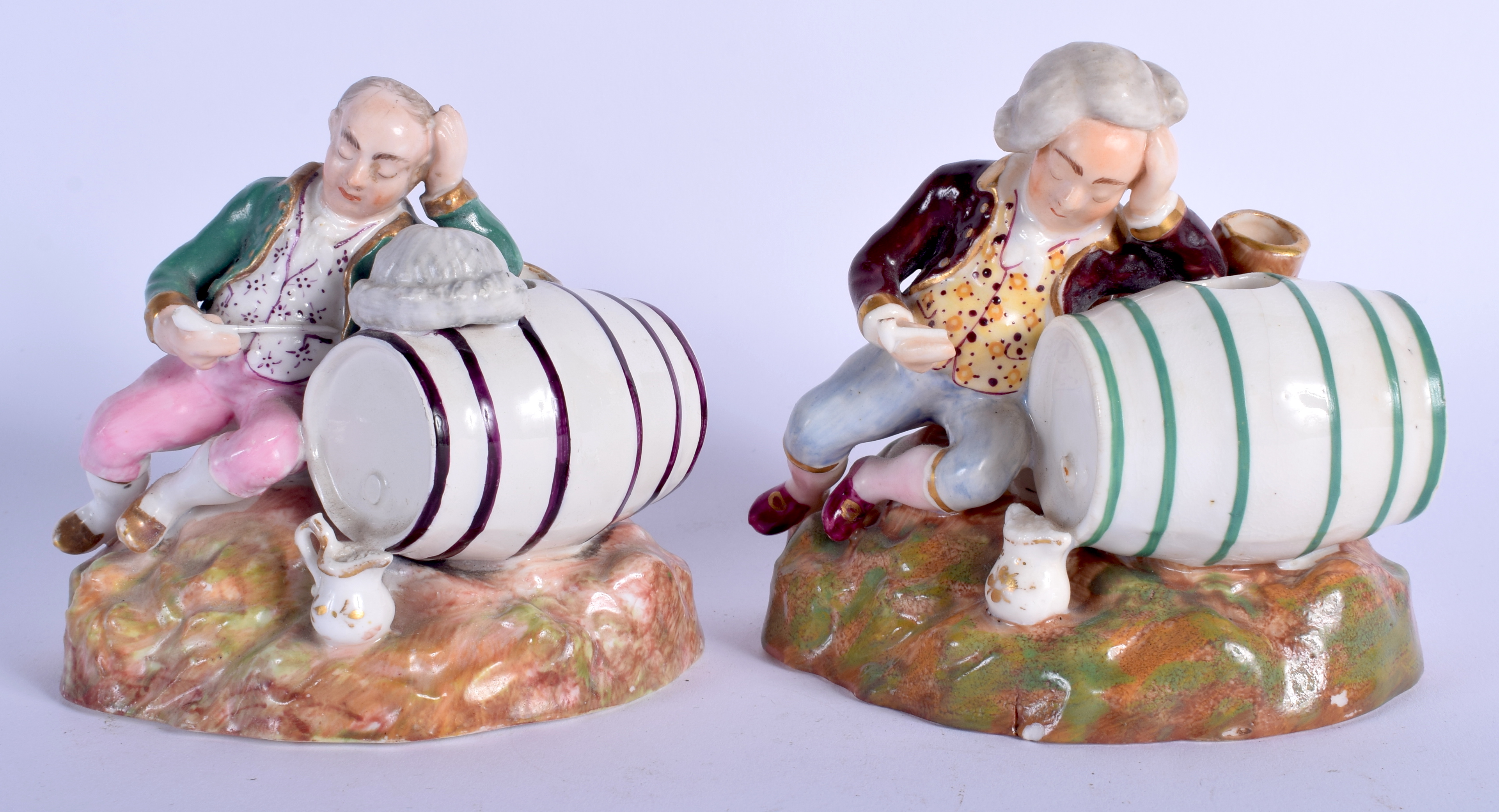 A RARE PAIR OF 19TH CENTURY ENGLISH PORCELAIN FIGURES modelled as two drunken males upon barrels. 8