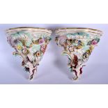 A PAIR OF 19TH CENTURY AUSTRIAN VIENNA PORCELAIN WALL BRACKETS painted with figures and landscapes.