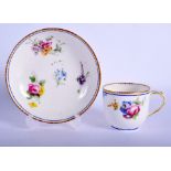 Sevres coffee cup and saucer painted with floral bouquets under a dentil gilt and blue line border