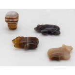 Four small carved agate pendants 2.5cm