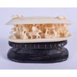 A 19TH CENTURY CHINESE CANTON CARVED IVORY CLAM SHELL. 5.5 cm x 3 cm.