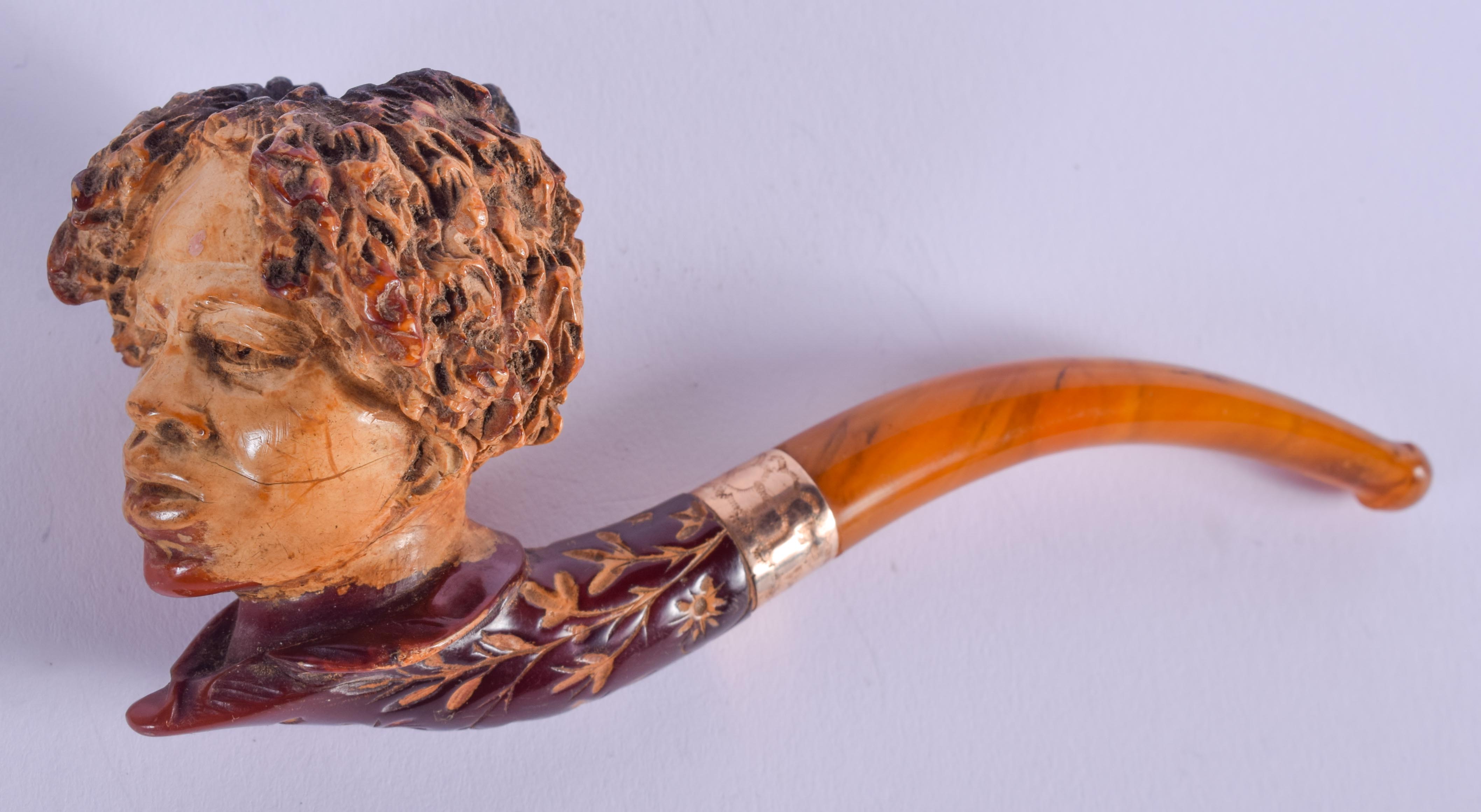 A 19TH CENTURY CONTINENTAL CARVED MEERSCHAUM AND AMBER PIPE. 13 cm long.