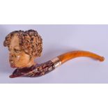A 19TH CENTURY CONTINENTAL CARVED MEERSCHAUM AND AMBER PIPE. 13 cm long.