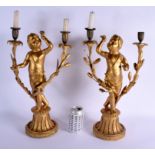 A PAIR OF 19TH CENTURY EUROPEAN GILT GESSO CHERUB CANDLESTICKS. 44 cm x 22 cm.