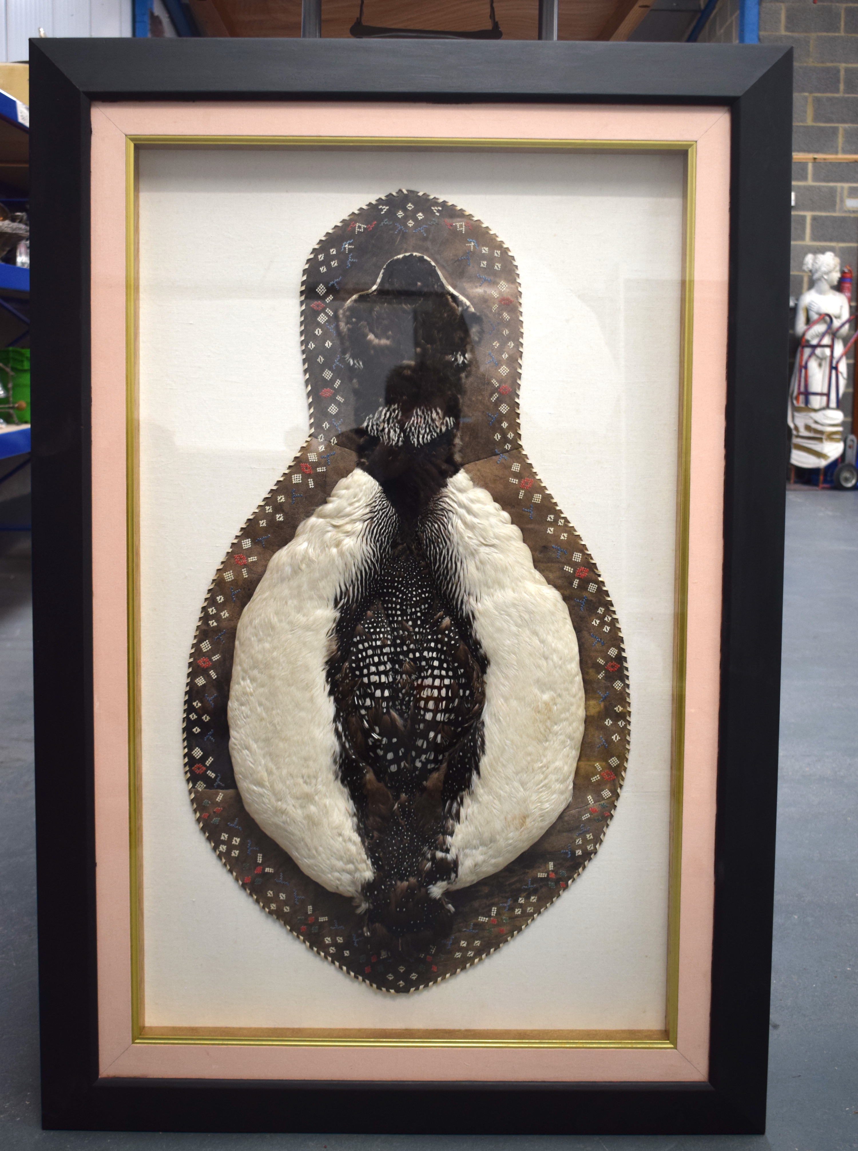 AN UNUSUAL FRAMED LOON BIRD SKIN RUG possibly Native American, with leather edge and leather work. S