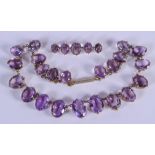 A LARGE VINTAGE AMETHYST NECKLACE with matching brooch. Necklace 34 cm long. (2)