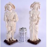 A LARGE PAIR OF 19TH CENTURY EUROPEAN DIEPPE CARVED IVORY FIGURES modelled upon wood bases. 33 cm hi