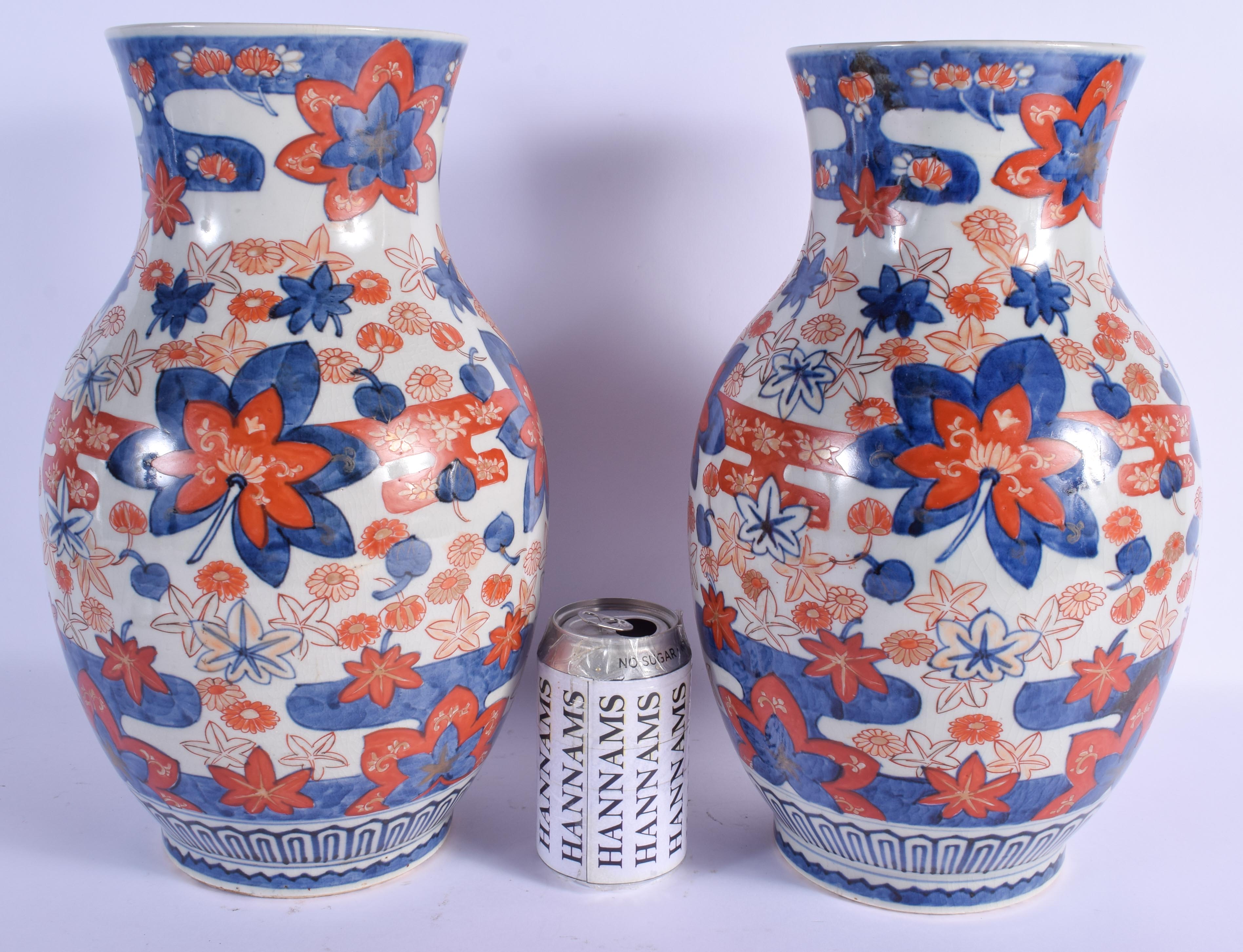 A LARGE PAIR OF 19TH CENTURY JAPANESE MEIJI PERIOD IMARI VASES painted with flowers. 37 cm x 15 cm.