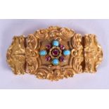 AN ANTIQUE YELLOW METAL TURQUOISE AND RUBY BUCKLE. 13 grams. 4.5 cm x 2.5 cm.