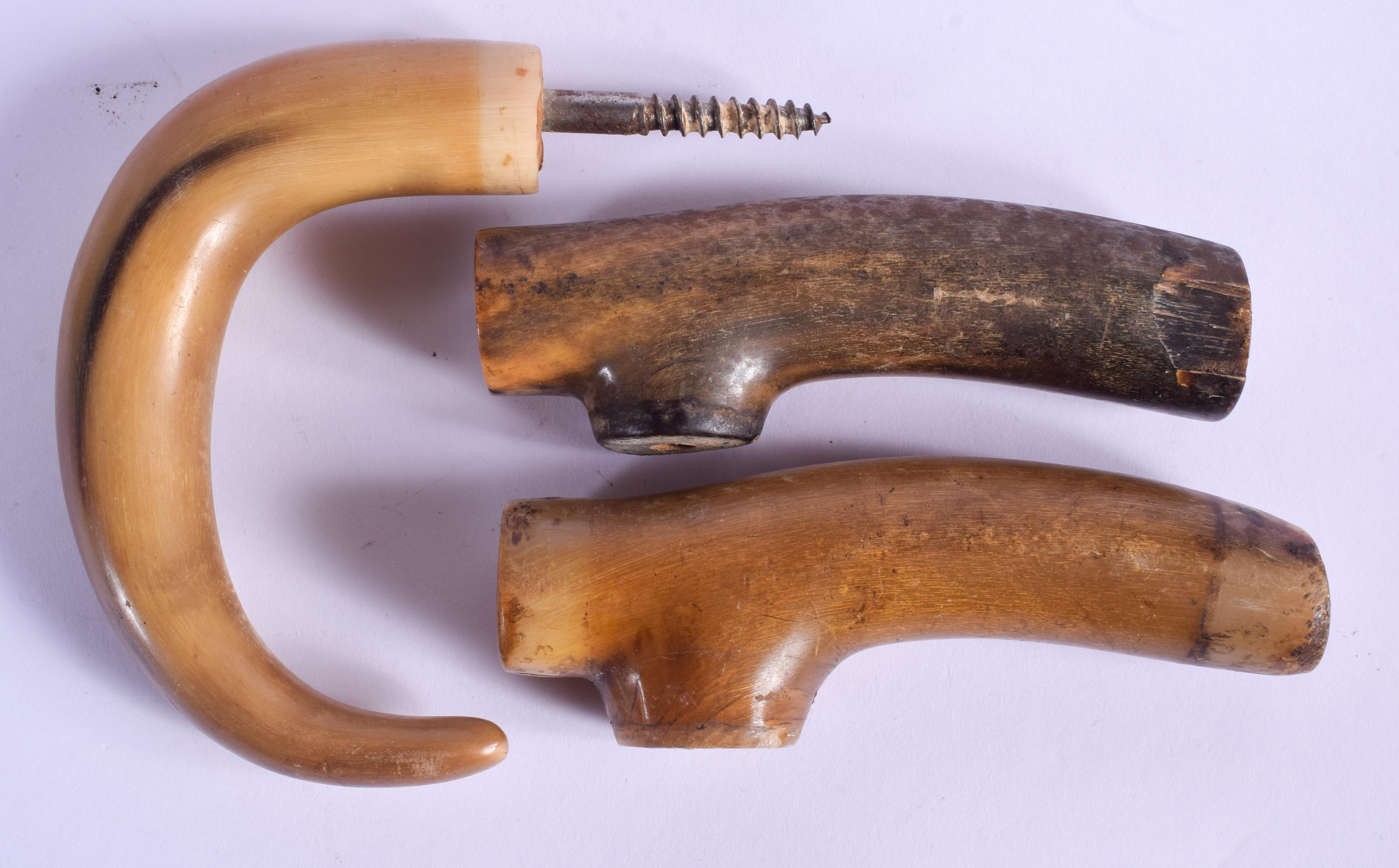 THREE 19TH CENTURY CARVED CONTINENTAL CARVED RHINOCEROS HORN HANDLES. Largest 11 cm wide. (3) - Image 2 of 2