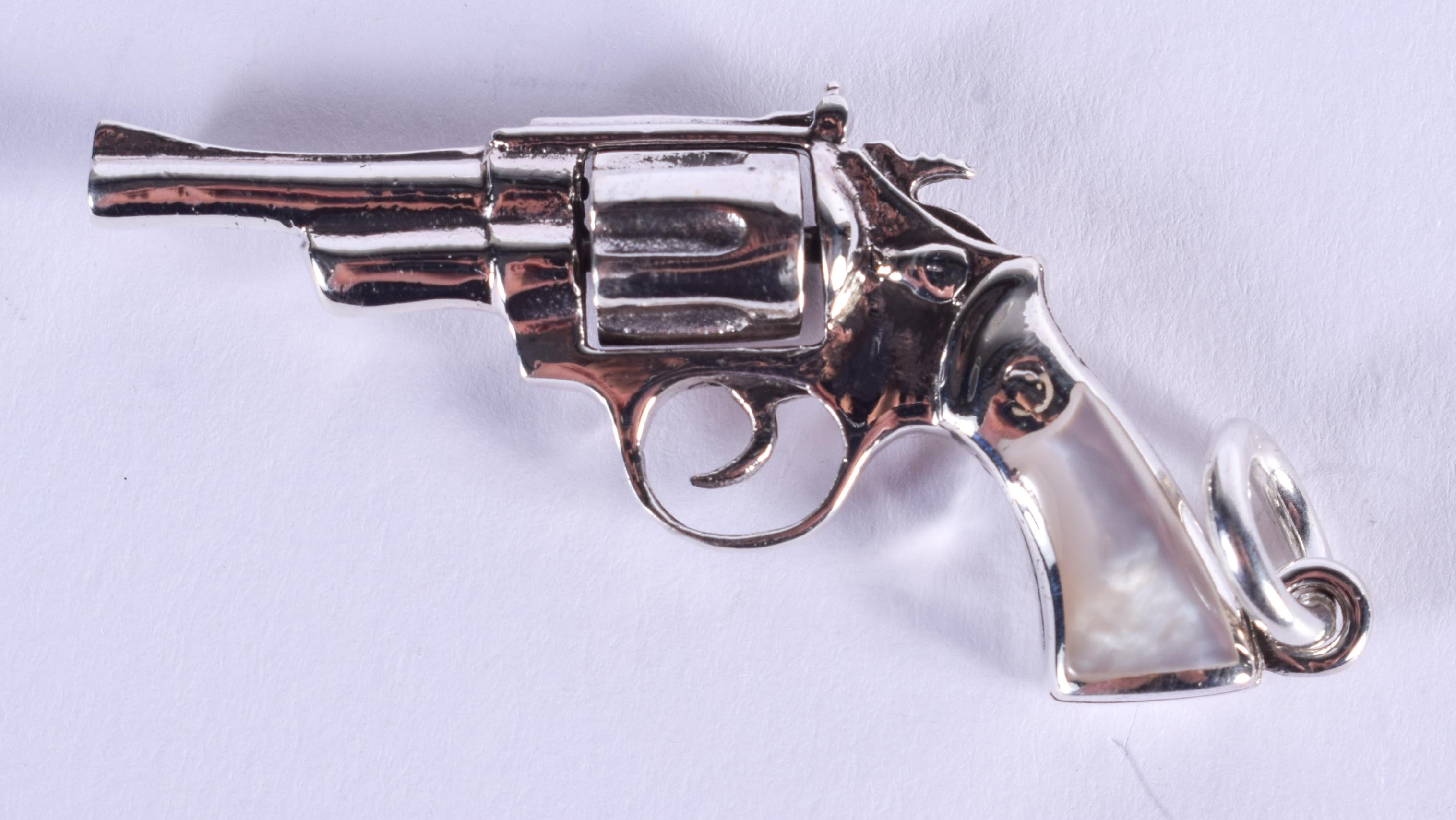 A SILVER AND MOTHER OF PEARL PISTOL. 5 cm wide.