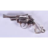 A SILVER AND MOTHER OF PEARL PISTOL. 5 cm wide.
