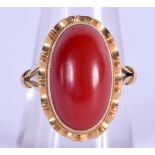 A VINTAGE GOLD AND CORAL TYPE STONE RING. 6.1 grams. N/O.