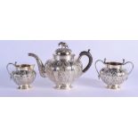 A 19TH CENTURY INDIAN THREE PIECE SILVER TEASET. 857 grams. Largest 19 cm x 19 cm. (3)