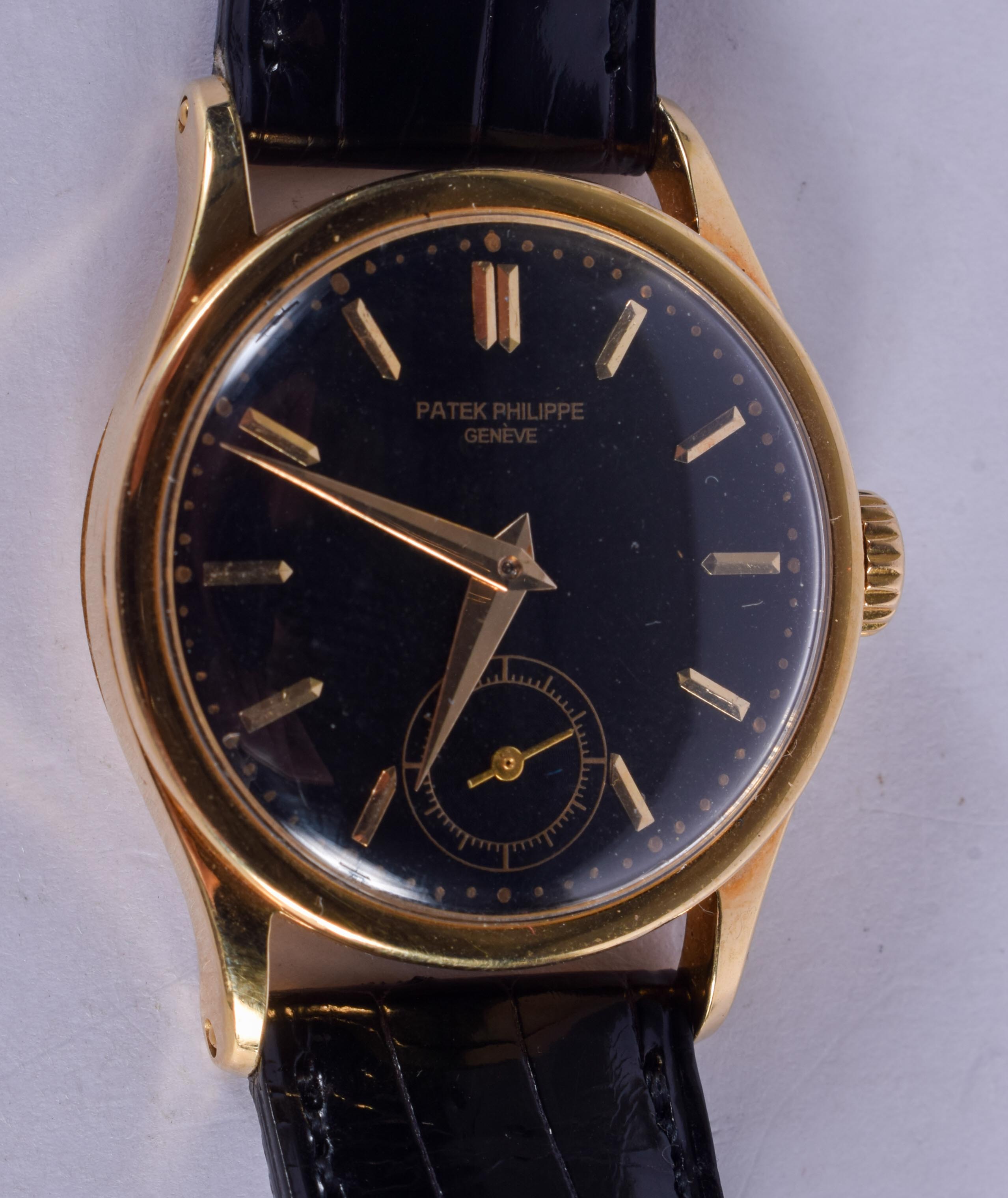 A RARE 18CT GOLD PATEK PHILIPPE BLACK DIAL WRISTWATCH with 18ct gold strap. Dial 3 cm diameter, Stra