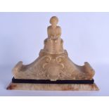 A RARE 19TH CENTURY CARVED ALABASTER CARVED PEDIMENT modelled as a seated Turk upon scrolling form.