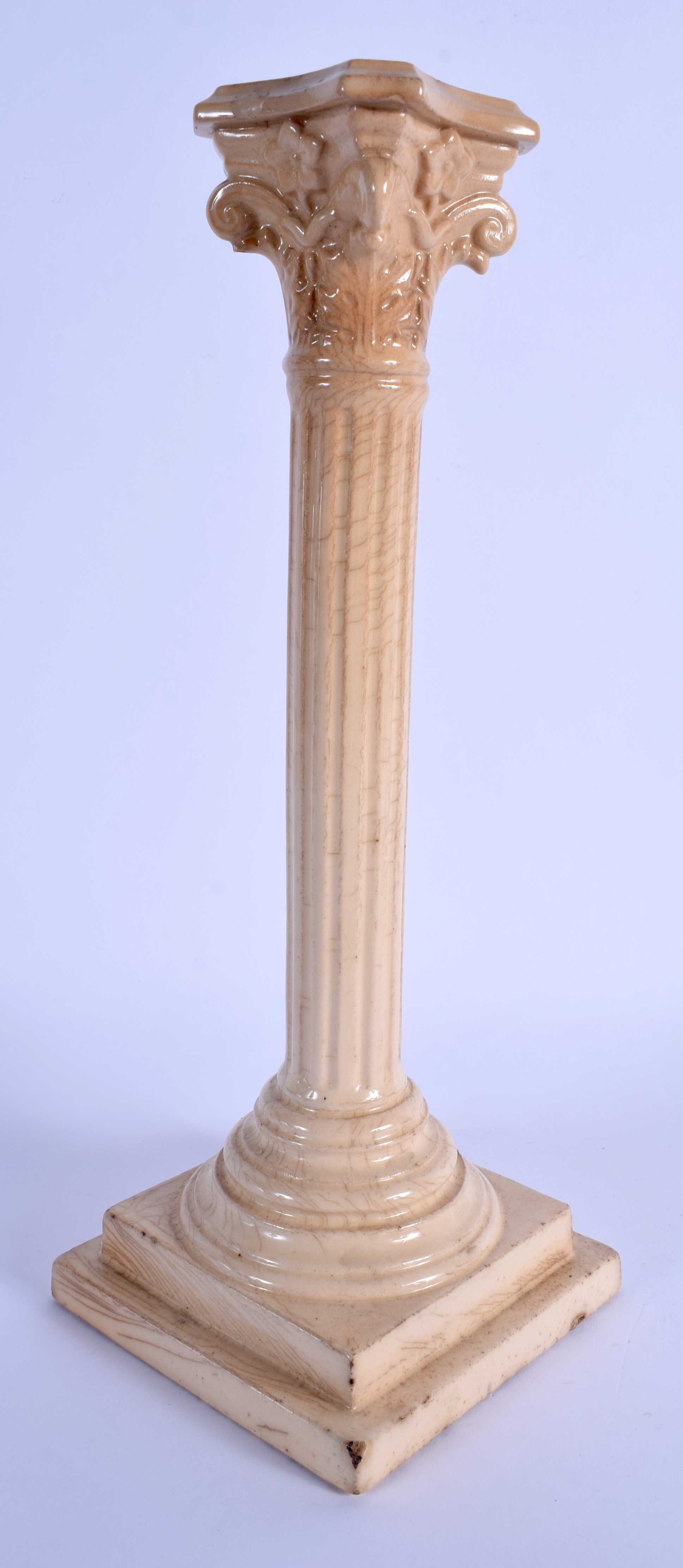 AN EARLY 19TH CENTURY EUROPEAN CREAMWARE POTTERY CANDLESTICK. 32 cm high.