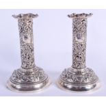 A PAIR OF ANTIQUE OPENWORK SILVER CANDLESTICKS. London. 499 grams possibly weighted. 15 cm high.