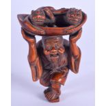 AN EARLY 20TH CENTURY JAPANESE MEIJI PERIOD CARVED BOXWOOD NETSUKE modelled as a male holding aloft