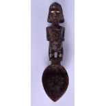 AN AFRICAN TRIBAL COFFEE BEAN EYED CARVED WOOD FIGURAL SPOON. 24 cm long.