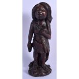 AN UNUSUAL TRIBAL CARVED WOOD FIGURE OF A STANDING FEMALE with bone eyes. 26 cm high.