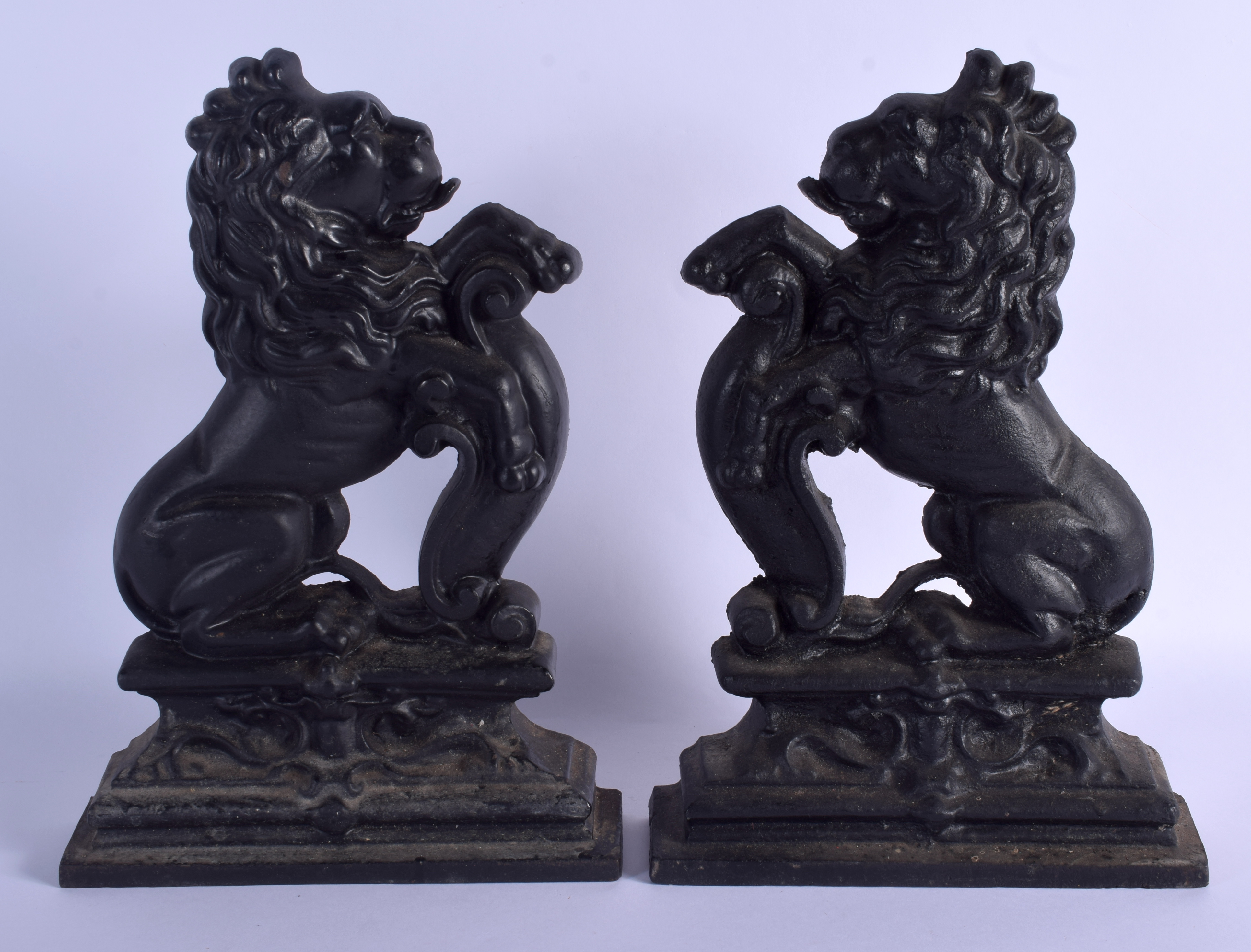 A PAIR OF 19TH CENTURY PAINTED CAST IRON LION DOOR STOPS. 35 cm x 21 cm.