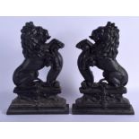 A PAIR OF 19TH CENTURY PAINTED CAST IRON LION DOOR STOPS. 35 cm x 21 cm.