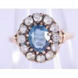 A GOLD LIGHT SAPPHIRE AND GEM SET RING. 3.1 grams. M.