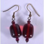 A PAIR OF 1920S CHERRY AMBER BAKELITE EARRINGS. 2.8 grams. 2 cm long.