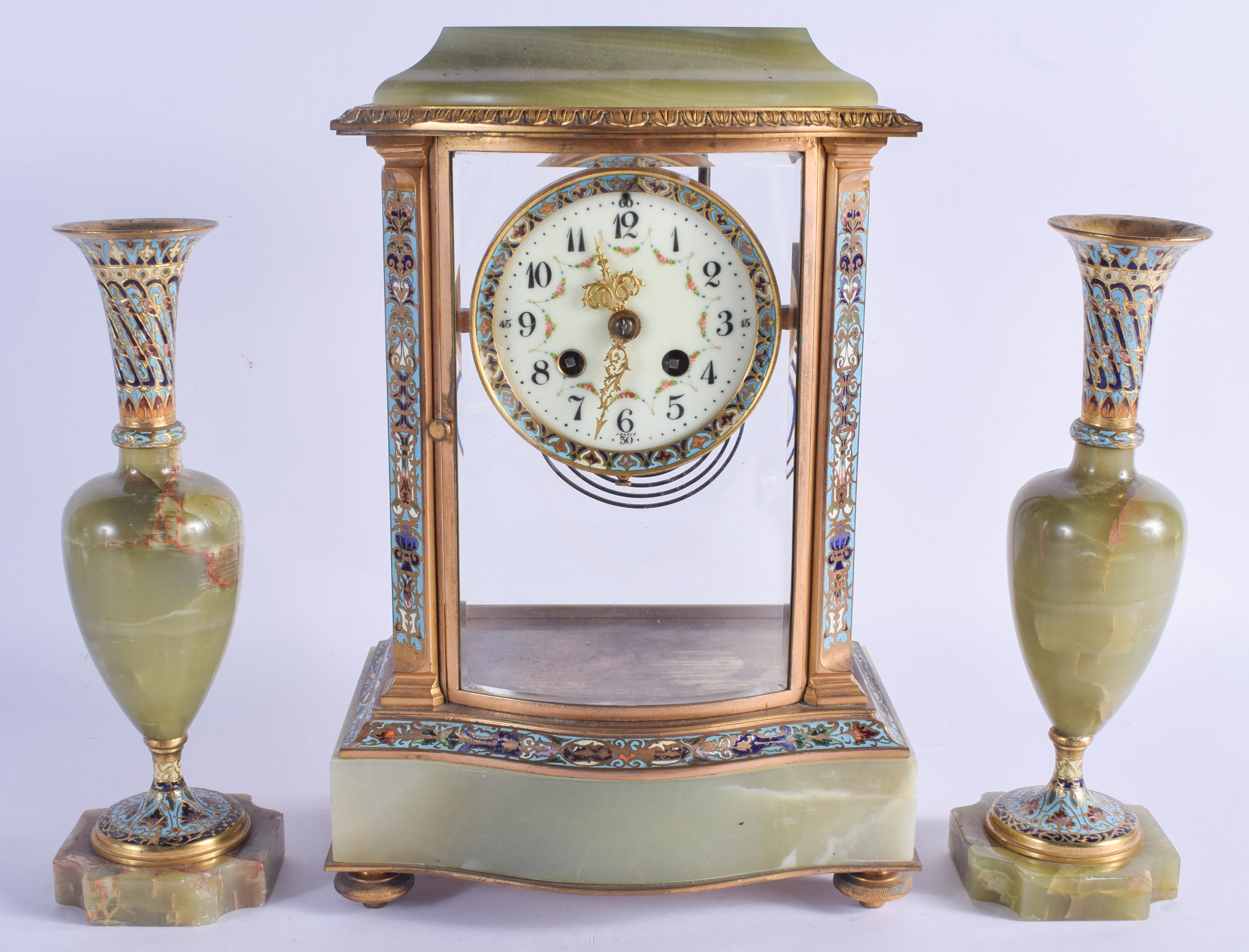 AN ANTIQUE FRENCH ONYX AND CHAMPLEVE ENAMEL CLOCK GARNITURE. Mantel 33 cm x 17 cm. (3)