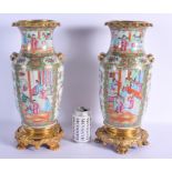 A LARGE PAIR OF 19TH CENTURY CHINESE CANTON FAMILLE ROSE VASES Qing, mounted in French ormolu. 40 cm