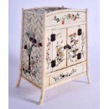A 19TH CENTURY JAPANESE MEIJI PERIOD CARVED SHIBAYAMA IVORY CABINET decorated with foliage and vines