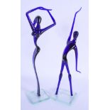 A RETRO PAIR OF EUROPEAN BLUE GLASS FIGURES. 32 cm high.