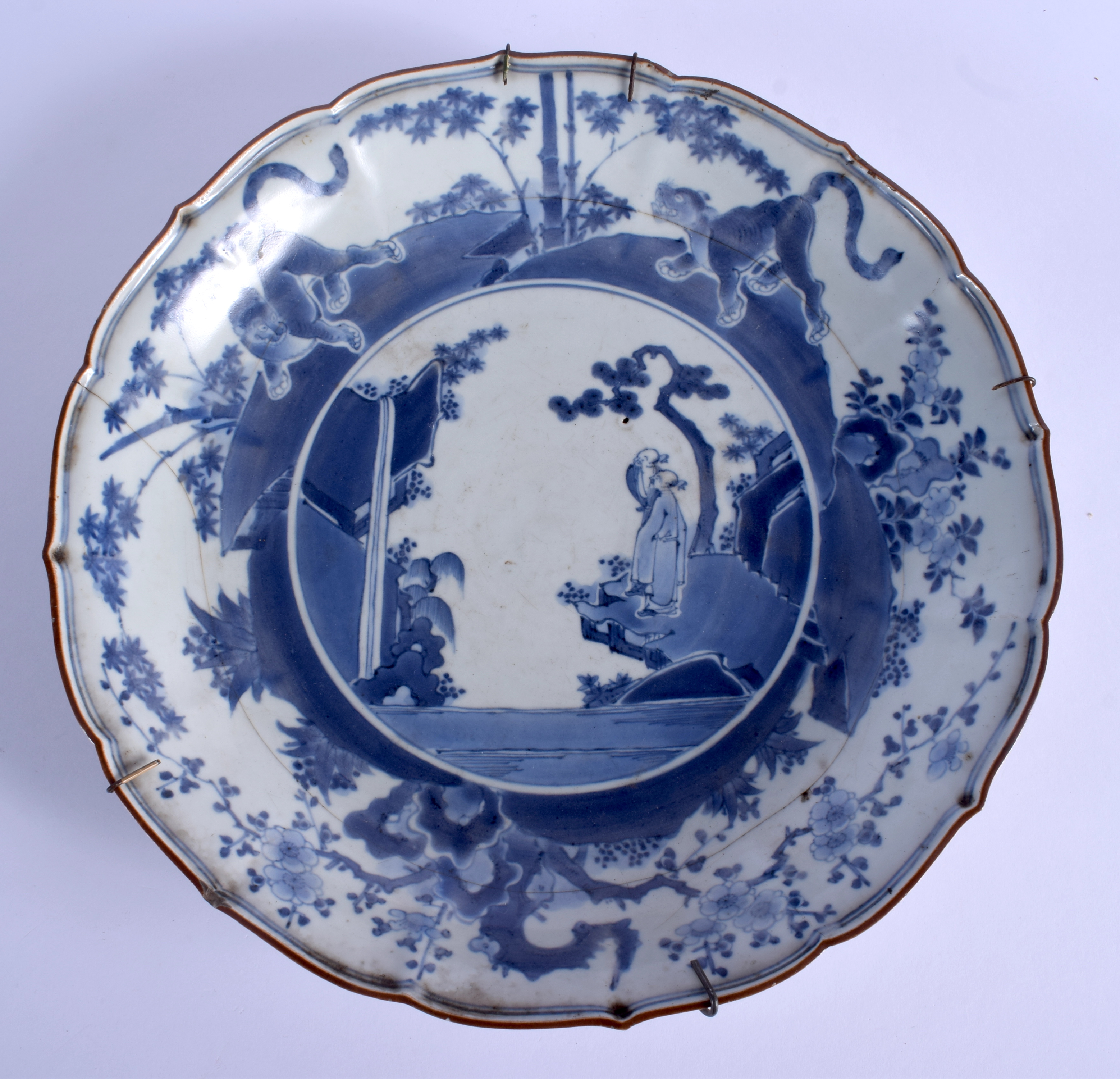 AN EARLY 18TH CENTURY JAPANESE EDO PERIOD BLUE AND WHITE SCALLOPED DISH painted with immortals. 30 c