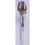 AN ANTIQUE SILVER AND MOTHER OF PEARL CADDY SPOON. 9 cm long.