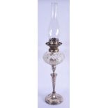 A LATE VICTORIAN/EDWARDIAN SILVER PLATED CANDLESTICK converted to an oil lamp. 48 cm not inc funnel.