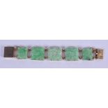 AN EARLY 20TH CENTURY 9CT GOLD JADEITE BRACELET carved with flowers. 40 grams. 19 cm x 2.5 cm.
