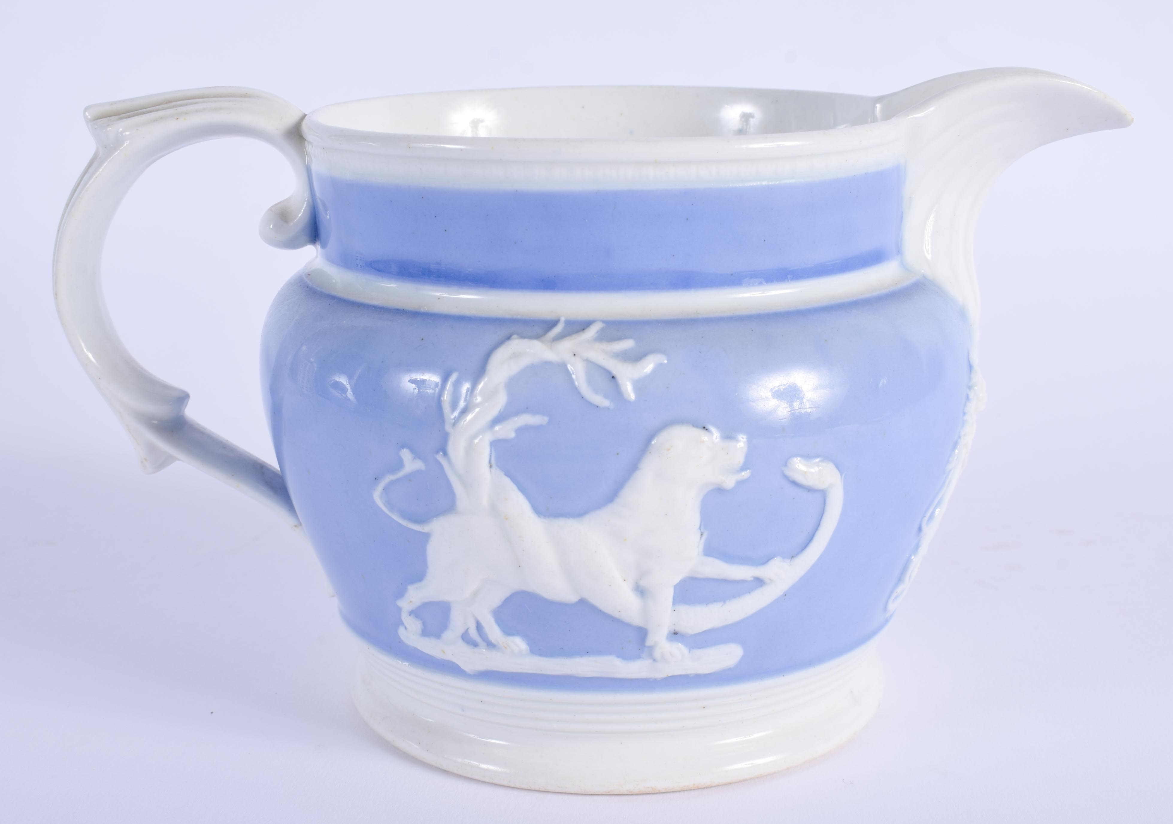 A 19TH CENTURY ENGLISH LAVENDER GLAZED POTTERY JUG decorated with moulded animals. 16 cm wide. - Image 2 of 3