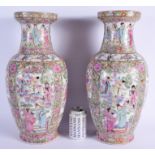 A LARGE PAIR OF CHINESE FAMILLE ROSE VASES 20th Century, painted with figures within landscapes. 46