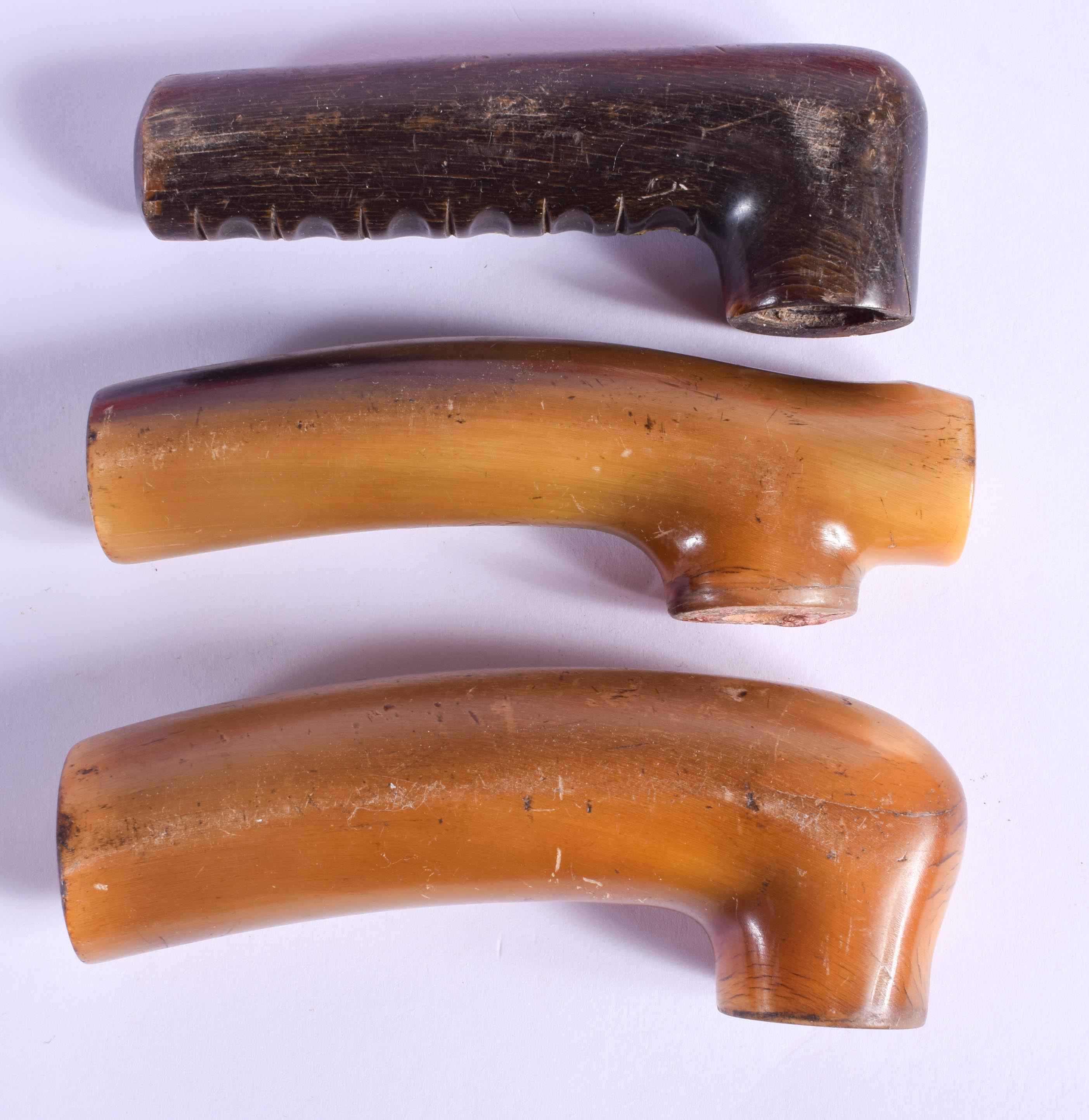 THREE 19TH CENTURY CARVED CONTINENTAL CARVED RHINOCEROS HORN WALKING CANE HANDLES. Largest 11 cm