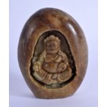 A LARGE CHINESE CARVED MOUNTAIN JADE BOULDER depicting a Buddhistic male. 9 cm x 5 cm.